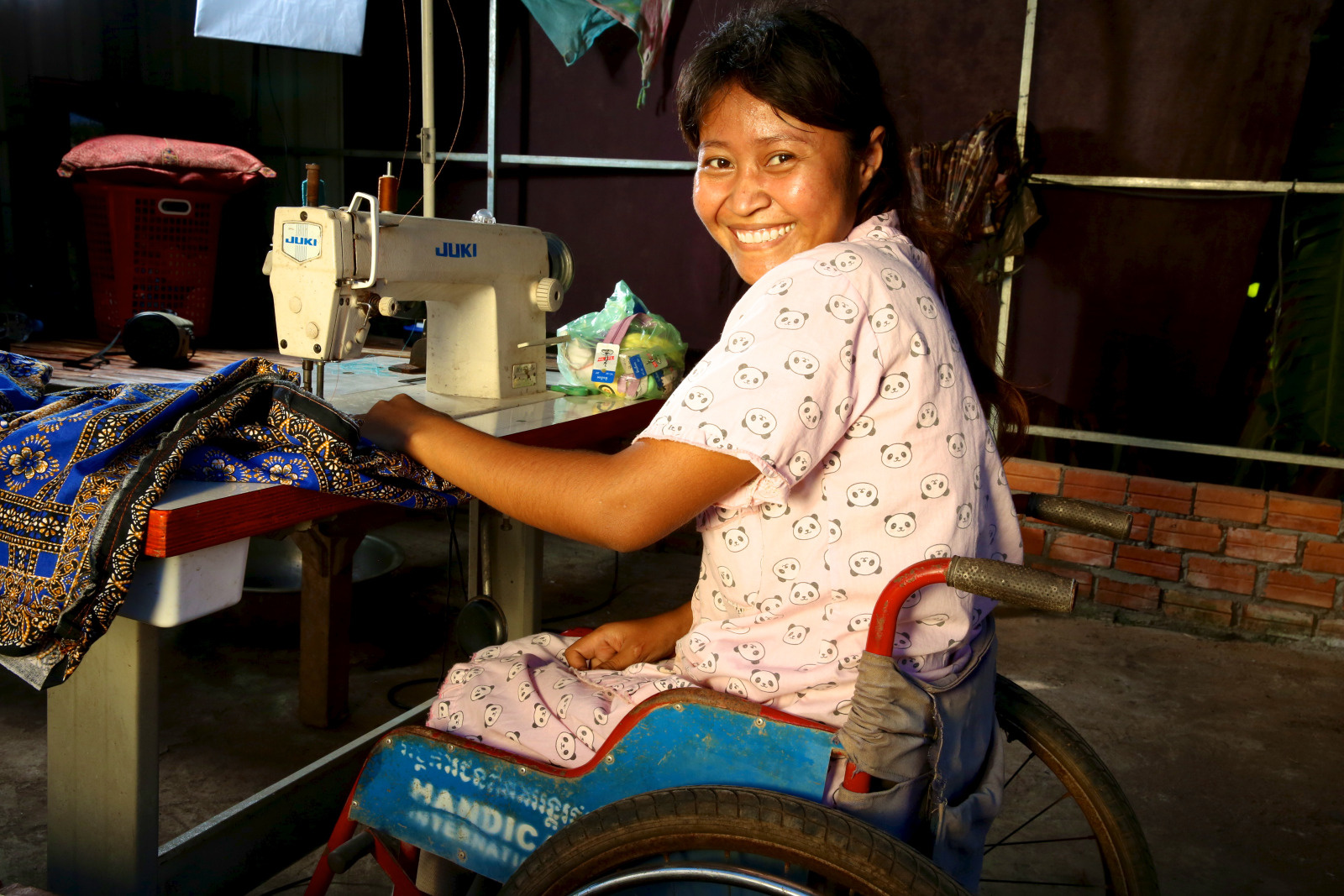 Srey Nuch has benefited from our rehabilitation services following an accident that cost her the use of her legs and from HI's socio-economic inclusion services. She is now able to walk with the help of orthotics and has started a small sewing business. © Stephen Rae/HI