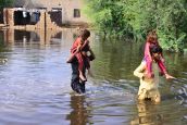 Floods victims wade through flood water after flash flood in Matiari, Sindh province, Pakistan on August 29, 2022.