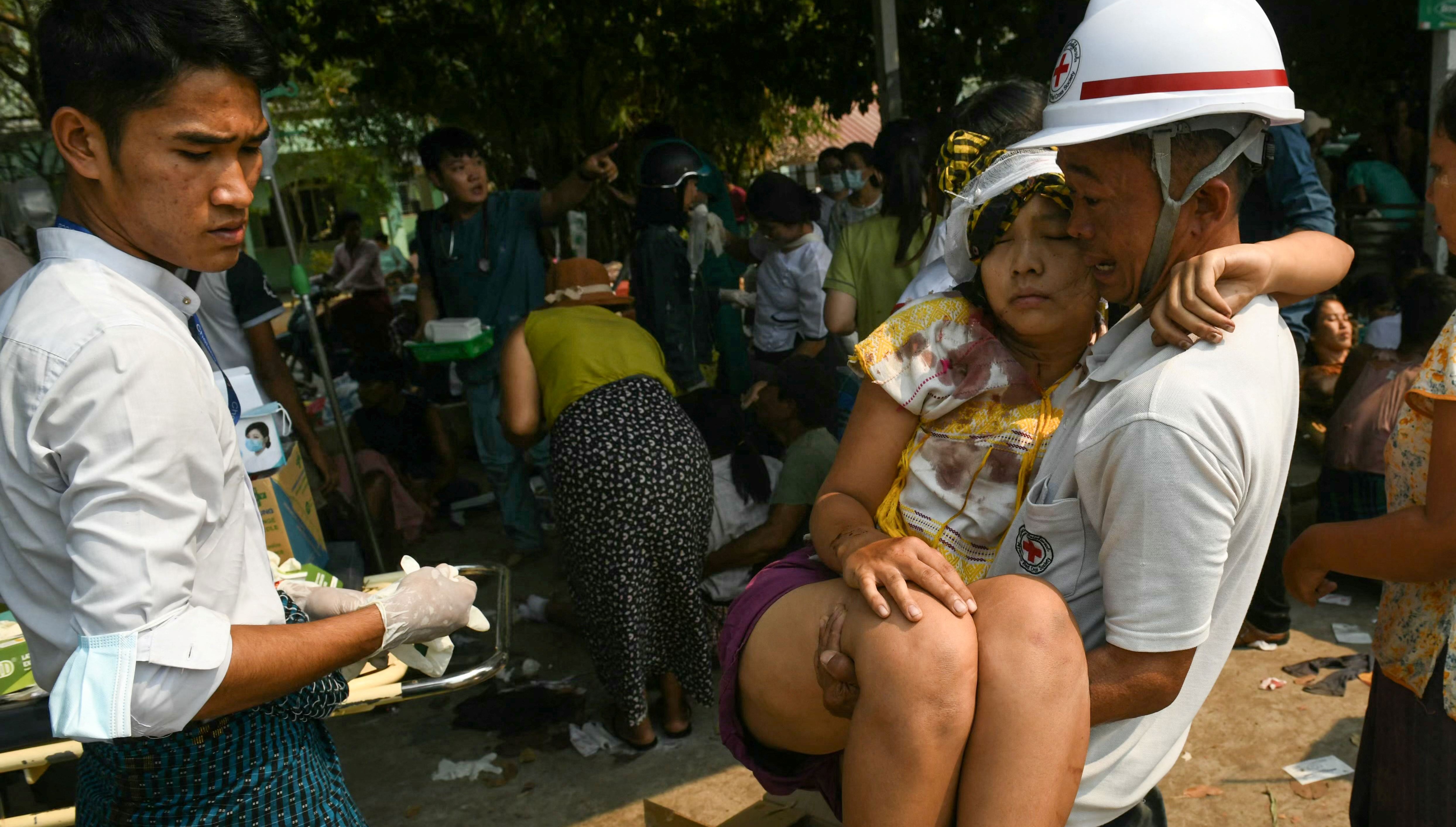 An earthquake survivor is carried as she waits to receive medical attention at a hospital in Naypyidaw on March 28, 2025