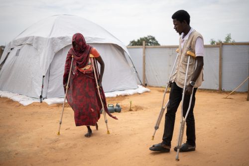 Disabled Women Walking With Crutches