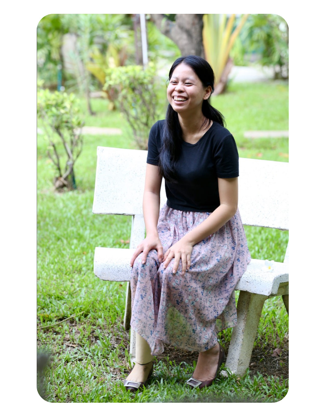 Woman with a prosthetic sitting and smiling outside