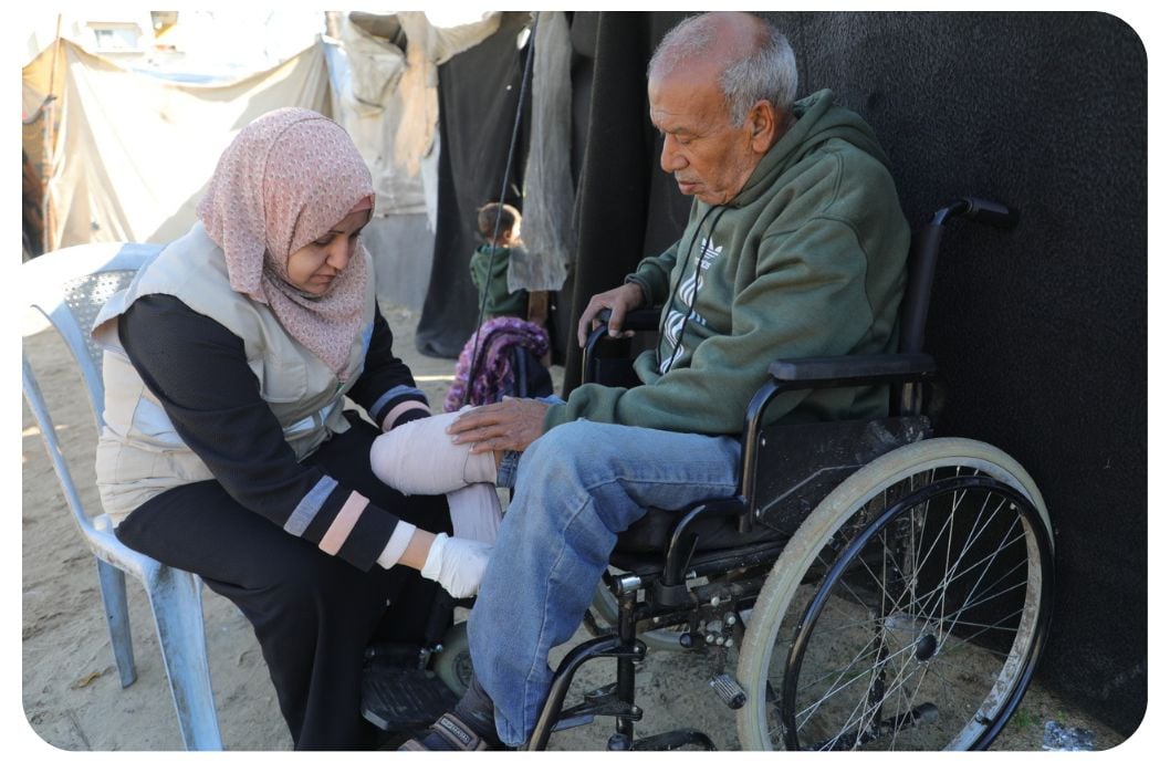 A woman helping someone with a disability.