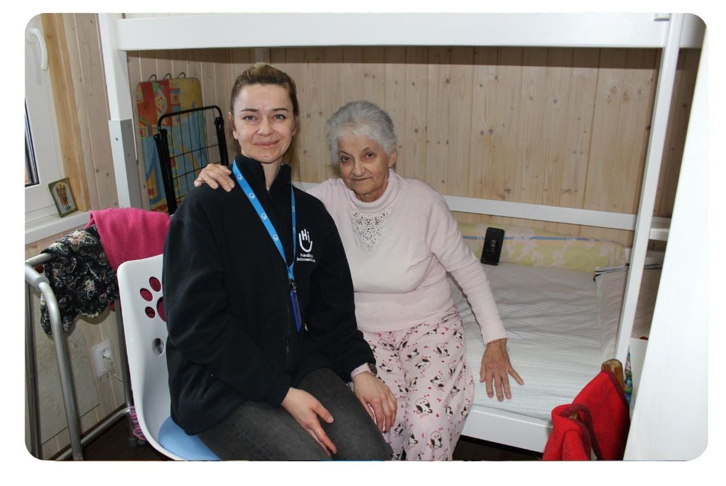 Woman smiling with an older woman.