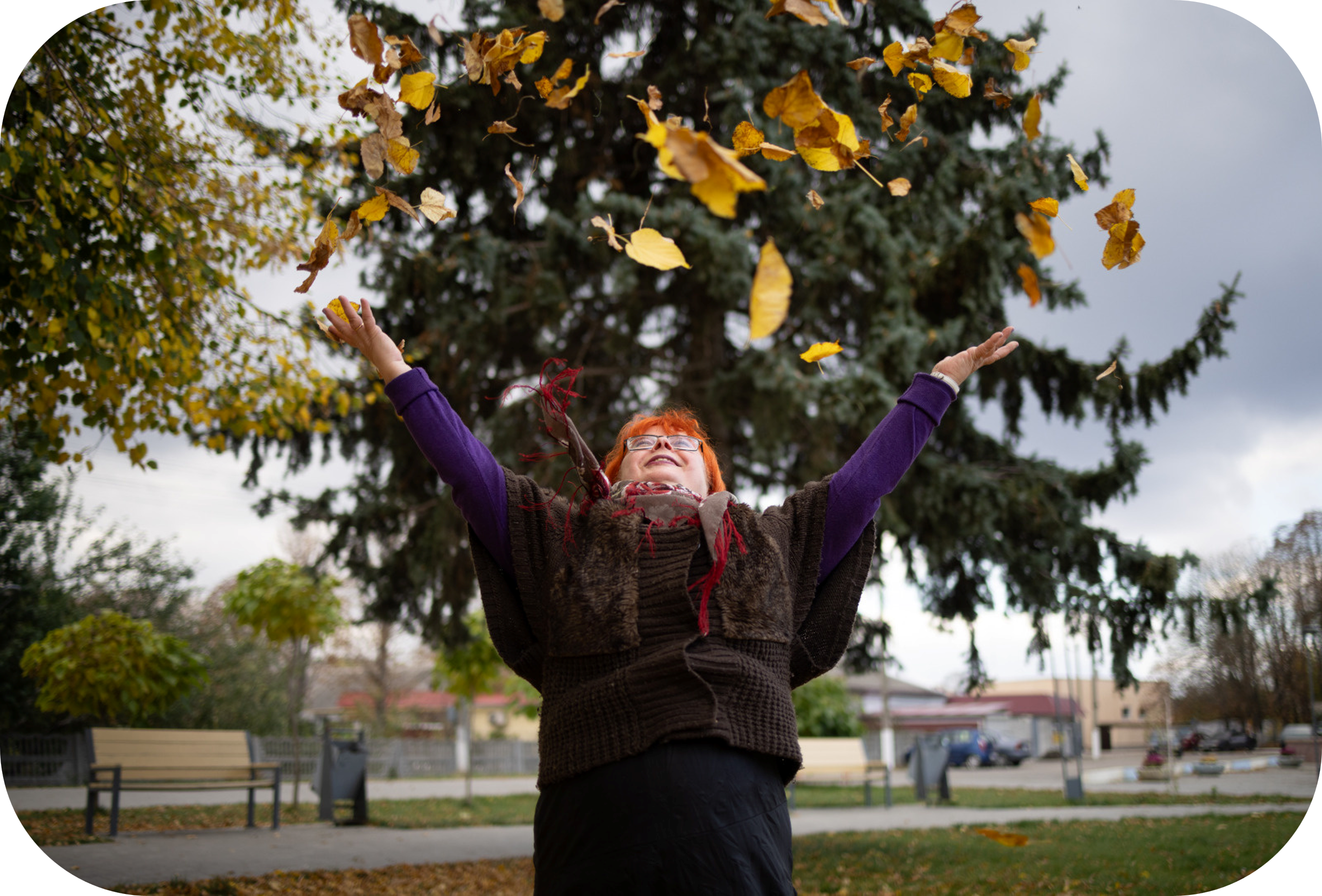 A woman throws leaves in the air