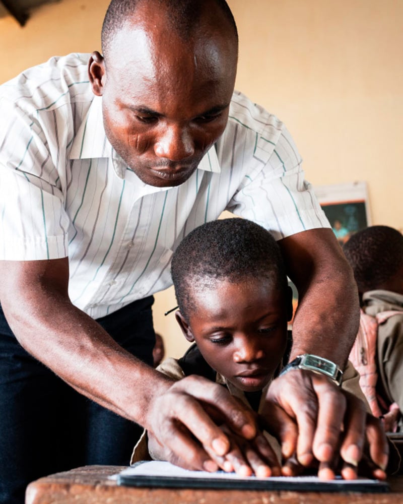 Trésor, 7 years old, is partially sighted. He learns Braille in an ordinary school