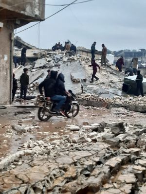 People in front of rubble