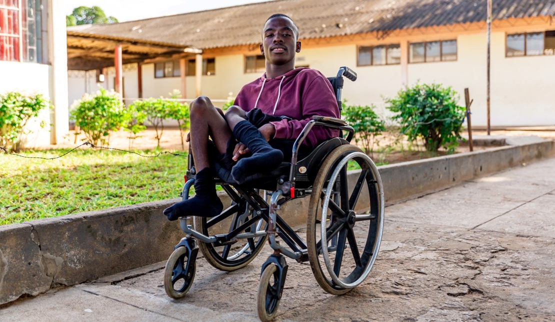 Mario, a young student from Madagascar in his wheelchair.