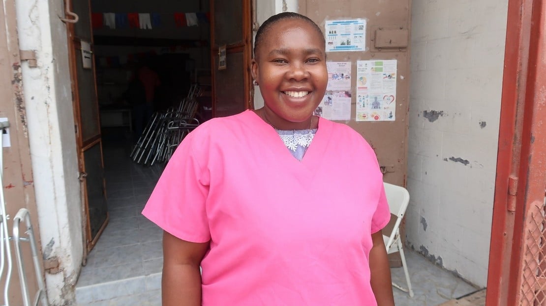 HI-trained rehabilitation technician, Guetchly-Nise smiles outside of a rehabilitation center in Cayes, Haiti. 2021