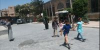 Zakarya (au second plan) marche dans la rue avec sa prothèse. 